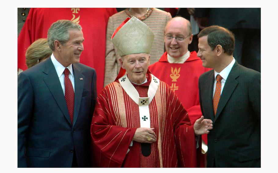 Former Catholic Cardinal Theodore McCarrick stands between former President George W. Bush, left, and Supreme Court Chief Justice John G. Roberts Jr. in October 2005. 