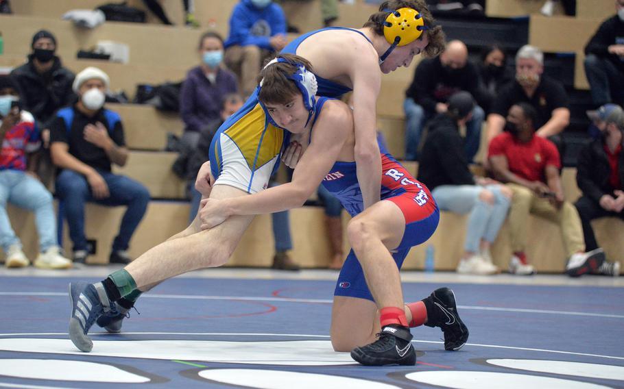 Ramstein’s Hayden Basham has a hold on Wiesbaden’s Patrick Iverson in the 144-pound final at the high school 2022 Wrestling Tournament in Ramstein, Germany, Feb. 12, 2022. Iverson went on to win the title.