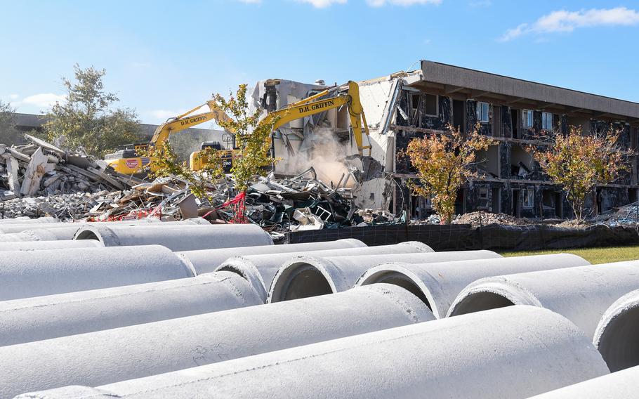 Construction workers demolish a former barracks building on Camp Lejeune, N.C., on Nov. 1, 2023. Dozens of construction projects are underway at the coastal North Carolina Marine base, including some $3.6 billion in renovations and new building projects authorized after Hurricane Florence caused major damage to the base in 2018. 