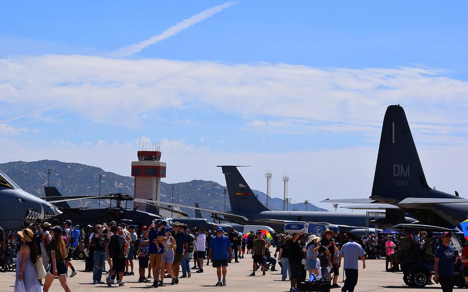 People walk around aircraft during an airshow