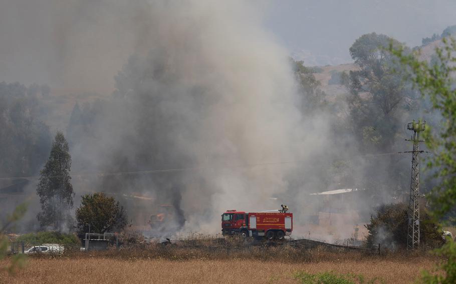 Firefighters respond to a fire near a rocket attack from Lebanon, amid ongoing cross-border hostilities between Hezbollah and Israeli forces, near Kiryat Shmona, northern Israel, June 14, 2024.