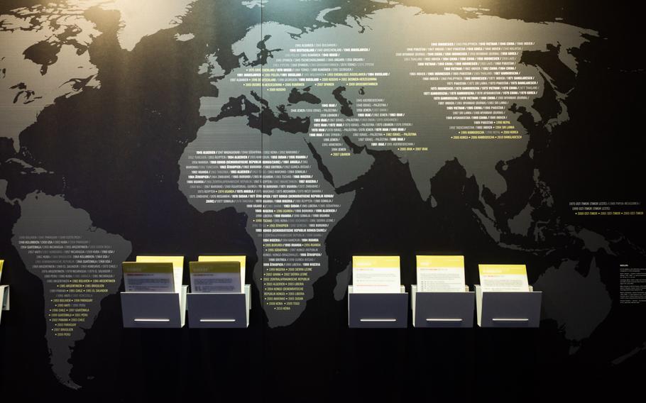 A world map with accompanying information cards at the Memorium Nuremberg Trials exhibition in Nuremberg, Germany, shows the extent of armed conflicts and war crimes between 1945 and 2000.