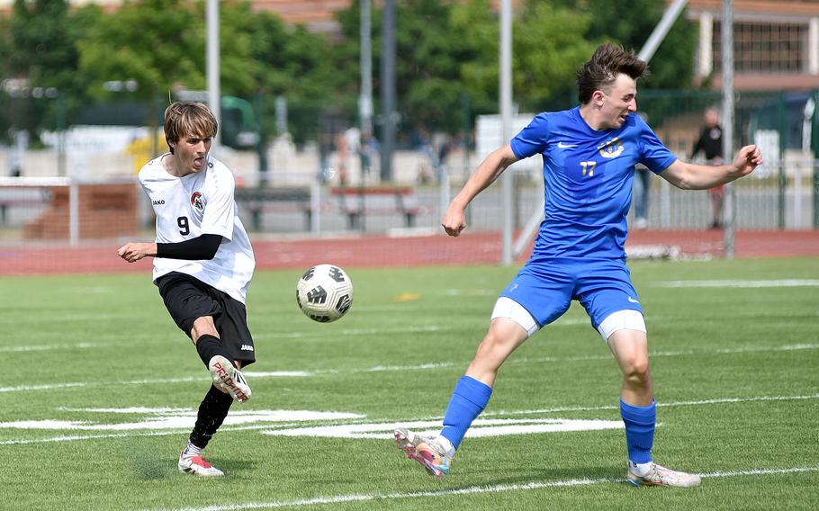 Kaiserslautern defender Max Worley clears the ball as midfielder Kai Woodstock turns his body while trying to block the ball during a Division I semifinal match at the 2025 DODEA European championships on May 21, 2025, at Kaiserslautern High School in Kaiserslautern, Germany.