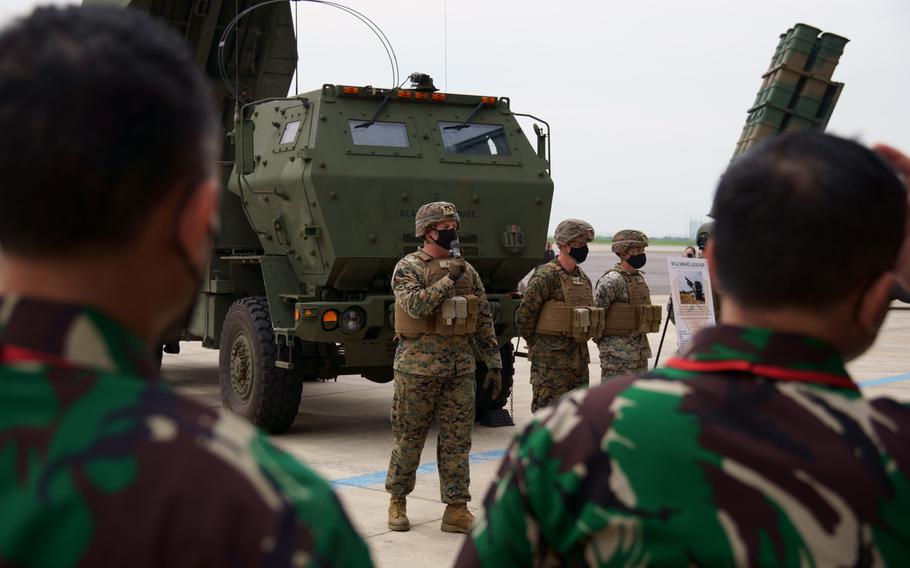 Indonesian officers observe a demonstration of the High Mobility Artillery Rocket System by US Marines at Camp Kisarazu in Tokyo on May 16, 2022. 