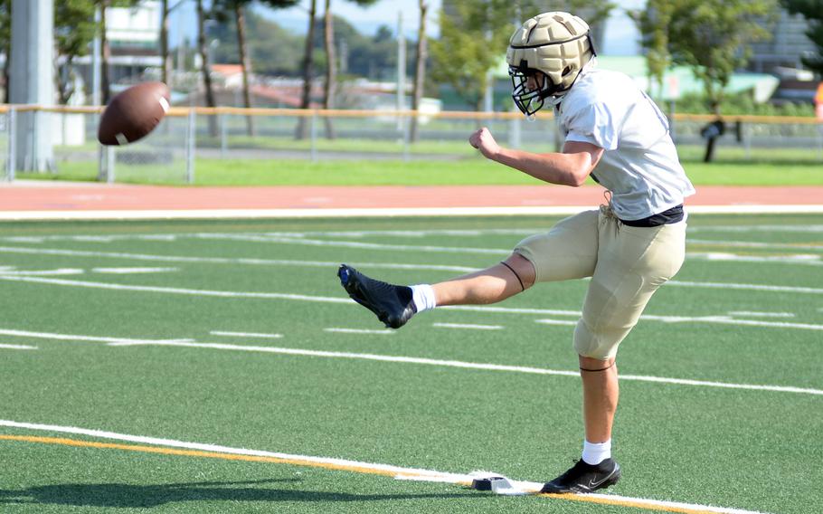 Reid Kenney kicks the ball.