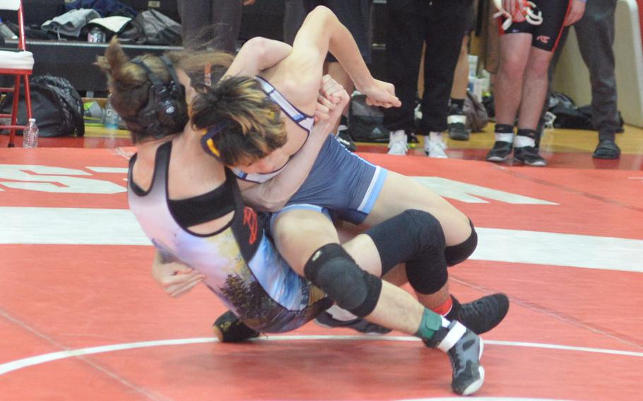 Yokota’s Tate Rannow pulls teammate Kaiyo Heinrichs toward the mat at 148 pounds en route a win by technical fall 11-1 and the weight-class title.