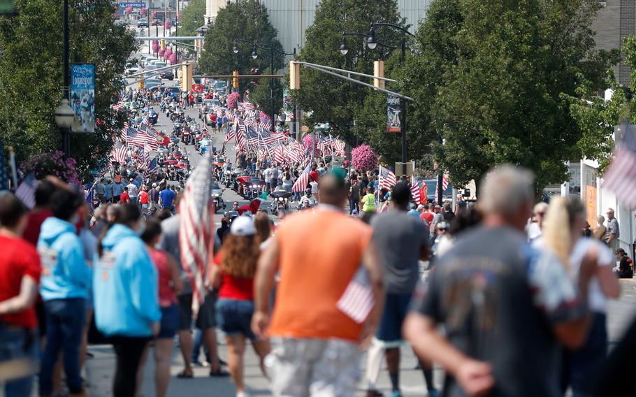 Thousands of people on motorcycles drive past the crowd during the funeral procession for Marine Corps Cpl. Humberto "Bert" Sanchez at the corner of 8th Street and East Market Street on Sept. 12, 2021, in Logansport, Ind.