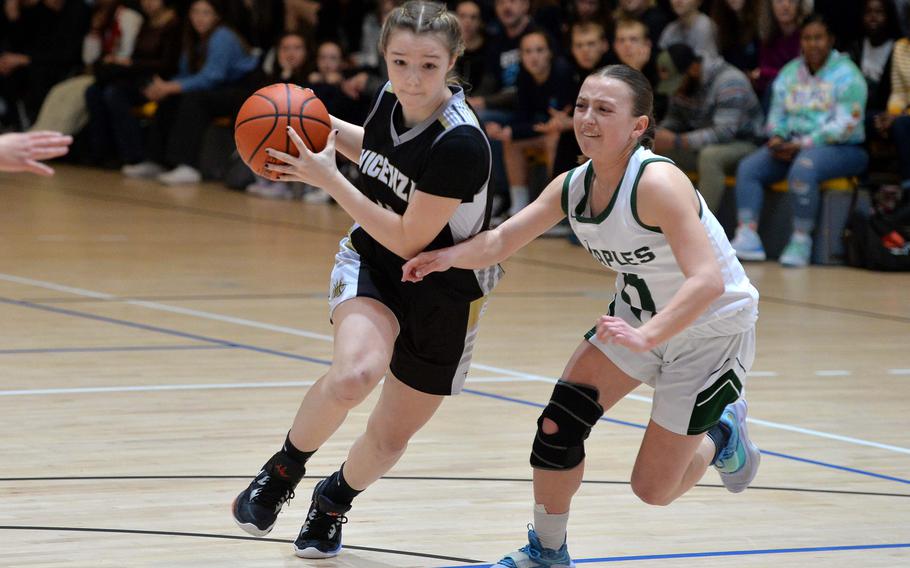 Vicenza’s Maya Fitch drives up the court against Naples’ Emma Kasparek in a Division II semifinal at the DODEA-Europe basketball championships in Ramstein, Germany, Feb. 17, 2023. The Wildcats beat the Cougars 46-39.