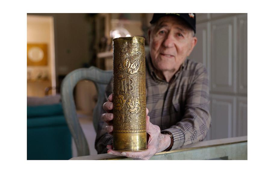World War II veteran and liberator Hilbert “Hibby” Margol on Wednesday, Jan. 17, 2024, holds a 75 mm howitzer shell casing that he found during the war.
