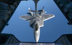An Air Force F-22 Raptor with the 90th Fighter Squadron, Joint Base Elmendorf-Richardson, Alaska, receives fuel from a KC-10 Extender during refueling over the Gulf of Mexico in November 2021. Six Raptors from the squadron arrived at RAF Lakenheath, England,on July 26, 2022, on their way to Poland, as part of NATO operations.