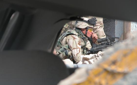 Saba al Boor, Iraq, Sep. 22, 2004: Spc. Alfredo Zendijias, Company C, 4th Battalion, 31st Infantry Regiment, 10th Mountain Division mans his machine gun and radios in an "all clear" outside the police station in Saba al Boor, Iraq. 

Read about Company C "one of the most deployed units in the Army" here. https://www.stripes.com/news/10th-mountain-on-yet-another-deployment-1.24496

META TAGS: Iraq; Operation Iraqi Freedom; U.S. Army; Company C, 4th Battalion, 31st Infantry Regiment, 10th Mountain Division;  