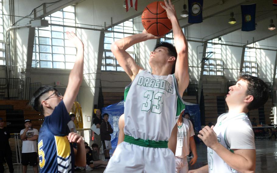 Kubasaki's Ryan Hater shoots against Taipei American during Saturday's Okinawa-American Friendship Tournament pool-play game.The Tigers won 60-42.