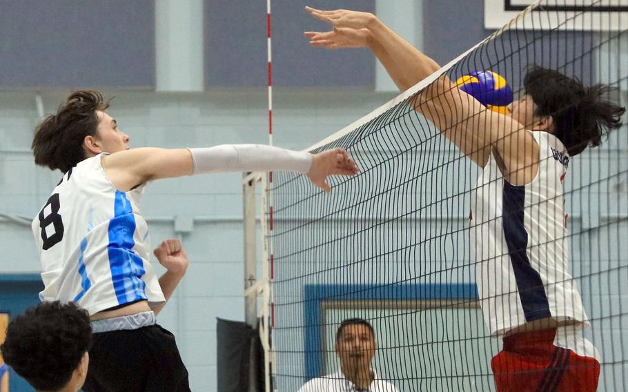 Osan's Benjamin Feldt spikes against Yongsan Internaitonal-Seoul's David Jin and Ryan Suh during Saturday's Korea boys volleyball match. The Guardians won in four sets.