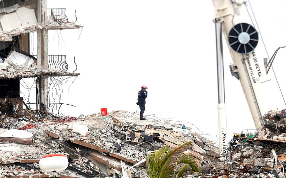 Search-and-rescue crews are working to recover missing people who were in the Champlain Towers South condominiums when it collapsed last week in Surfside, Fla., June 28, 2021. 