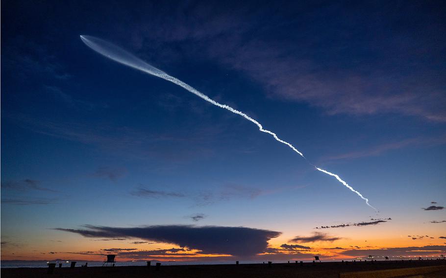 The launch of SpaceX Falcon 9 rocket with 22 Starlink satellites is viewed from Huntington Beach, California, at dusk after taking off from Vandenberg Space Force Base on March 18, 2024.