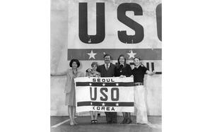 Seoul, South Korea, March 1973:  Staff members of the USO Seoul holds up the flag of their office. From left to right: June Choy, assistant director USO Seoul; Rosie Choi; Clarke Cook, Seoul USO director of activities; Kate Ginman;  Denise Clay. Apart from staff, the location maintains a volunteer staff of about 300 people who assist an average of 35,000 servicemen each month at the 24-hour location. 

USO Korea is celebrating its 50th anniversary this year!

META TAGS: USO; Seoul; South Korea; military life; United Service Organizations; entertainment