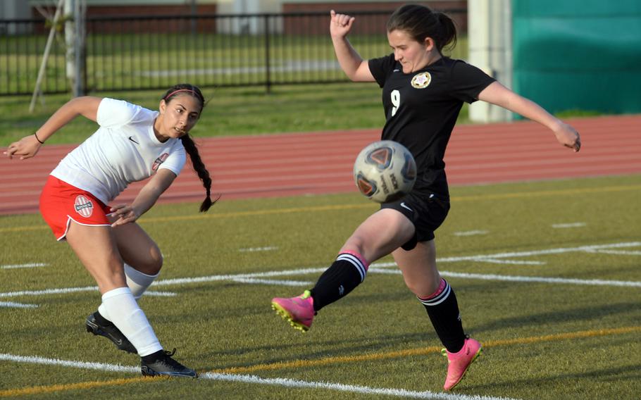 Nile C. Kinnick's Rachael Vite boots the ball past Matthew C. Perry's Victoria Theberge during Friday's DODEA-Japan girls soccer match. The Red Devils won 2-1.