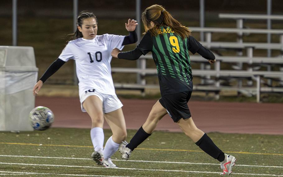 Robert D. Edgren’s Saige Whitmore boots the ball past Zama‘s Sara Zambrano during Friday’s DODEA-Japan girls soccer match. The Trojans won 1-0.