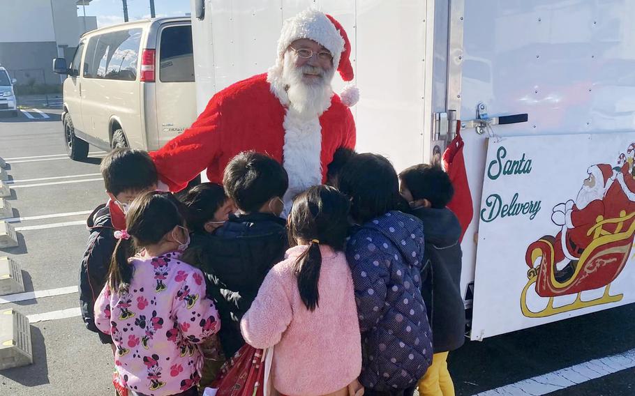 Navy veteran Ervin Lawrence has been dressing as Santa to spread holiday cheer to the less fortunate in Japan for the past seven years.