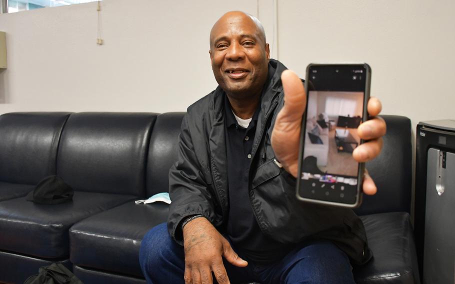 Army veteran Andrew Shelton, 66, shows off a photo of his home on Wednesday, Feb. 23, 2022. With the help of the organization U.S. Vets, Shelton was able to transition last year from homelessness to renting his own apartment. 