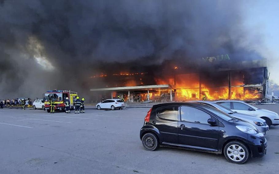 In this image made from video provided by Ukrainian State Emergency Service, firefighters work Monday, June 27, 2022, to extinguish a fire at a shopping center burned after a rocket attack in Kremenchuk, Ukraine.