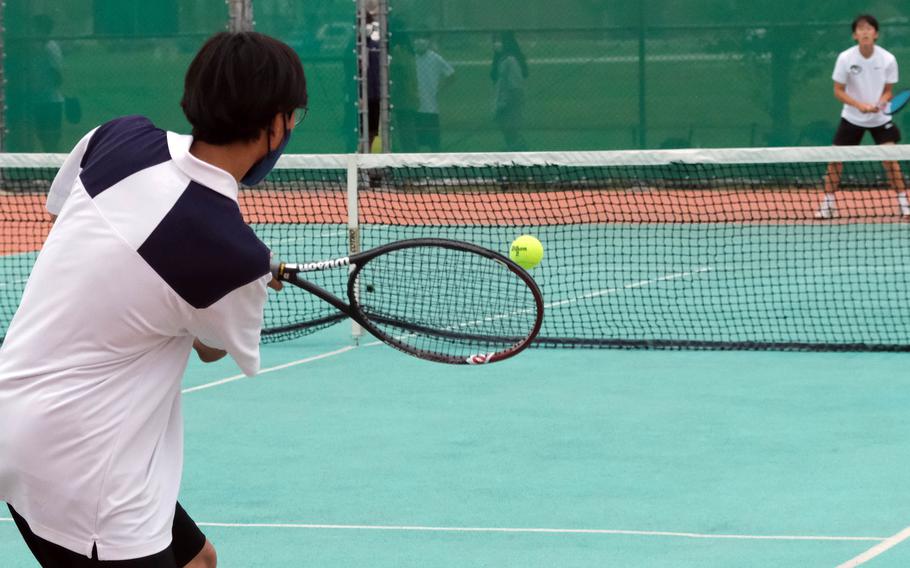 Chanho Choe of Osan sends a backhand to Humphreys’ Caleb Kim during Friday’s Korea tennis matches. Choe beat Kim 8-5.