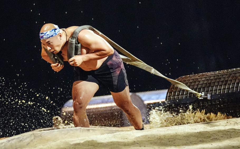 U.S. Army Maj. Gibson Kim drags a 330-pound weight during a taping for Netflix’s “Physical: 100” in Goyang, South Korea.