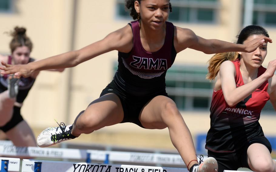 Naviah Blizzard, one of Zama‘s group of young sprinters, navigates a hurdle during Saturday’s season-opening meet.