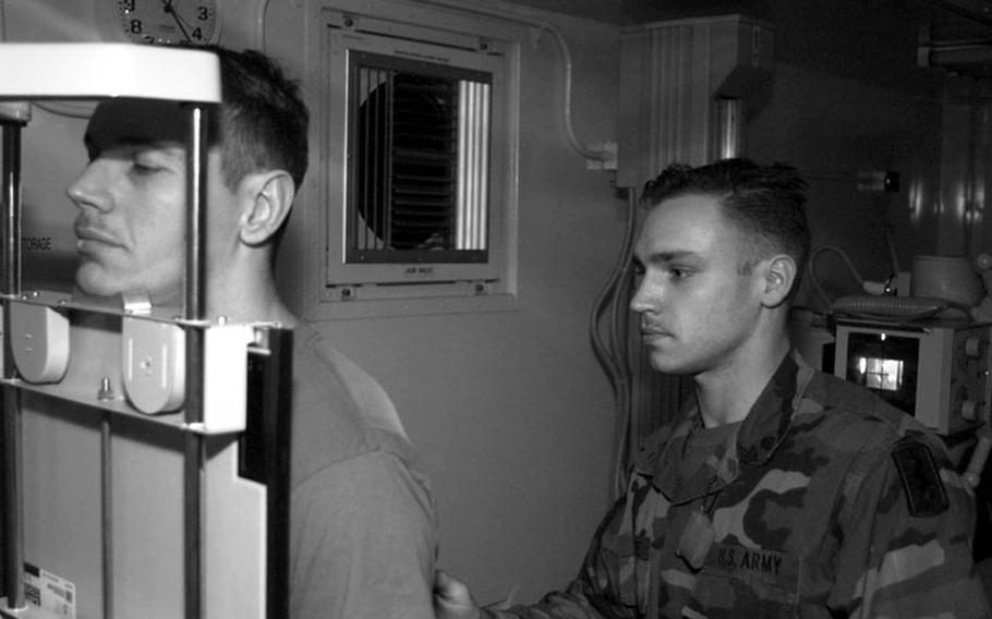 Taszar AB, Hungary, January, 1996: An Army corpsman takes X-rays of a patient at Taszar's medical facility, one of the most advanced field hospitals ever deployed.