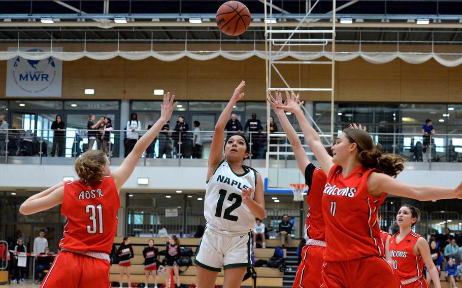 Naples’ Anais Navidad aims for the basket between AOSR’s Charlotte Burgas-Sims, left, and Natalia DiMatteo in the girls Division II final at the DODEA-Europe basketball championships in Wiesbaden, Germany, Feb. 17, 2024. The Wildcats took the title, beating AOSR 48-29.