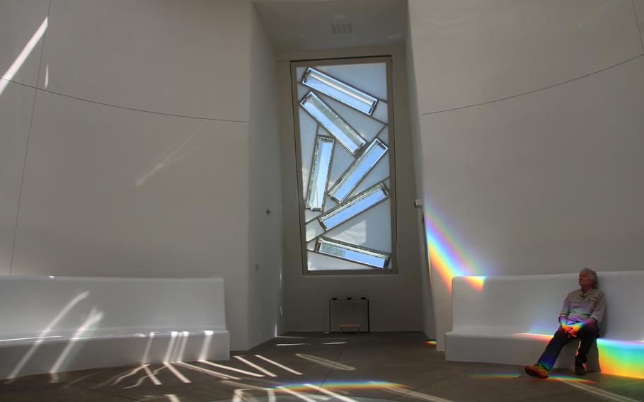The Dwan Light Sanctuary at United World College in Montezuma near Las Vegas uses light, prisms and rainbows to create an atmosphere of serenity and peace. Here, Las Vegas resident Frank Beurskens enjoys a moment of quiet reflection. 