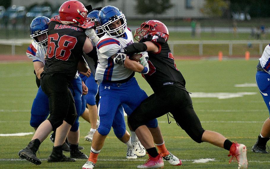 Ramstein running back Landon Torroll powers through a tackle by Raider linebacker Connor Kelly during the second quarter of a Sept. 15, 2023, game at Babers Stadium in Kaiserslautern, Germany. Torroll scored a 7-yard touchdown on the play.