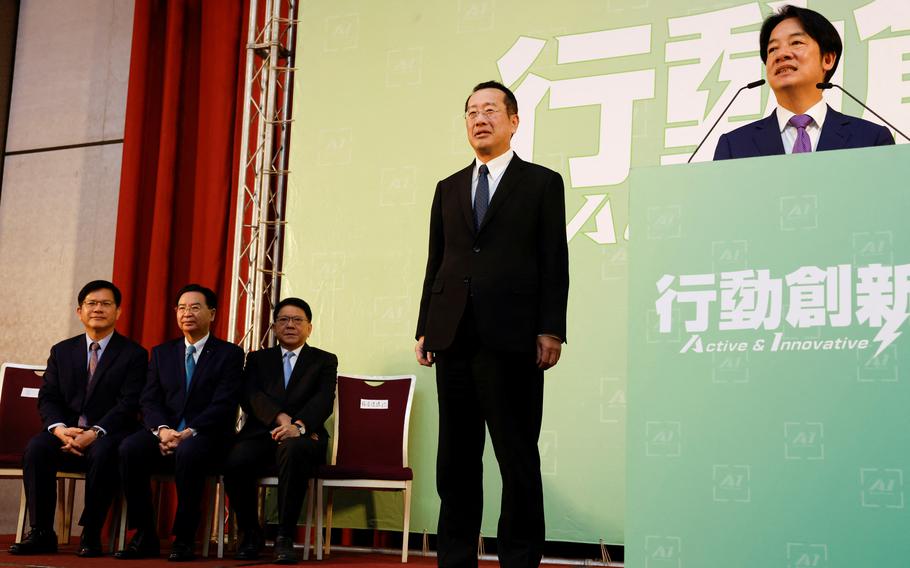 Incoming Defense Minister Wellington Koo stands next to Taiwan President-elect Lai Ching-te while he speaks during a press conference where incoming cabinet members are announced, in Taipei, Taiwan April 25, 2024.