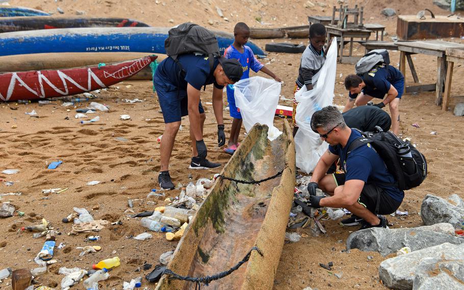 Crew members assigned to USCGC Mohawk participate in a beach cleanup with 350 kids at Vridi Beach in Abidjan, Ivory Coast, Aug. 15, 2022. 