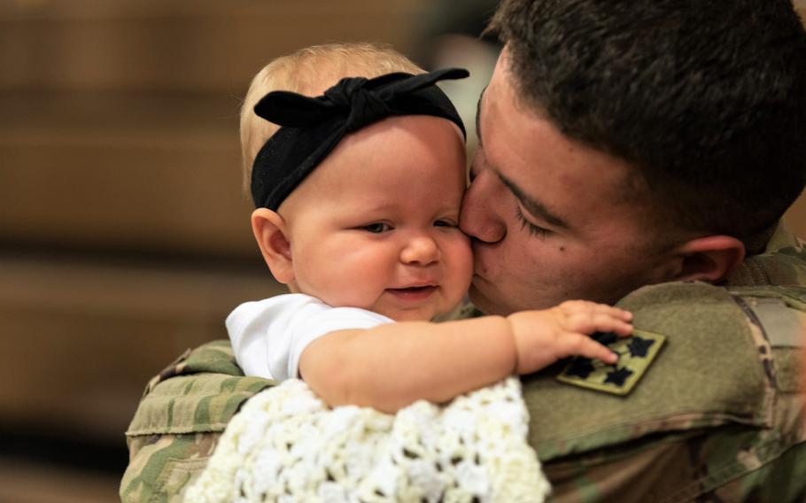 Army Spc. Dallas Ochoa, assigned to the 2nd Infantry Brigade Combat Team, 4th Infantry Division, reunites with his daughter, Kaylynn, following a homecoming ceremony at Fort Carson, Colo., in 2018. 