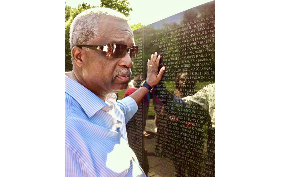 James Rollins stands at the Vietnam Veterans Memorial in Washington on Veterans’ Day this year. Rollins said that he has found the names of many of the soldiers he served with on the memorial.