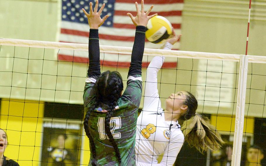 Kadena's Lia Connolly spikes against Kubasaki's Ayeli Rocha during Tuesday's Okinawa volleyball match. The Dragons won in four sets and won the season series 3-1.