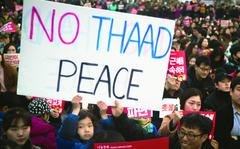 A sign protesting the Terminal High Altitude Area Defense, or THAAD, anti-missile system appears during a demonstration in Seoul, South Korea, March 11, 2017. 