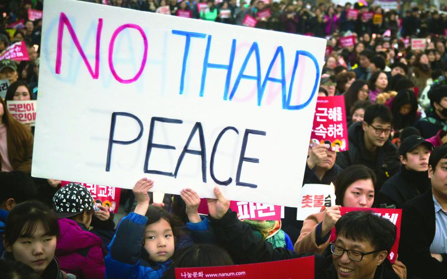 A sign protesting the Terminal High Altitude Area Defense, or THAAD, anti-missile system appears during a demonstration in Seoul, South Korea, March 11, 2017. 