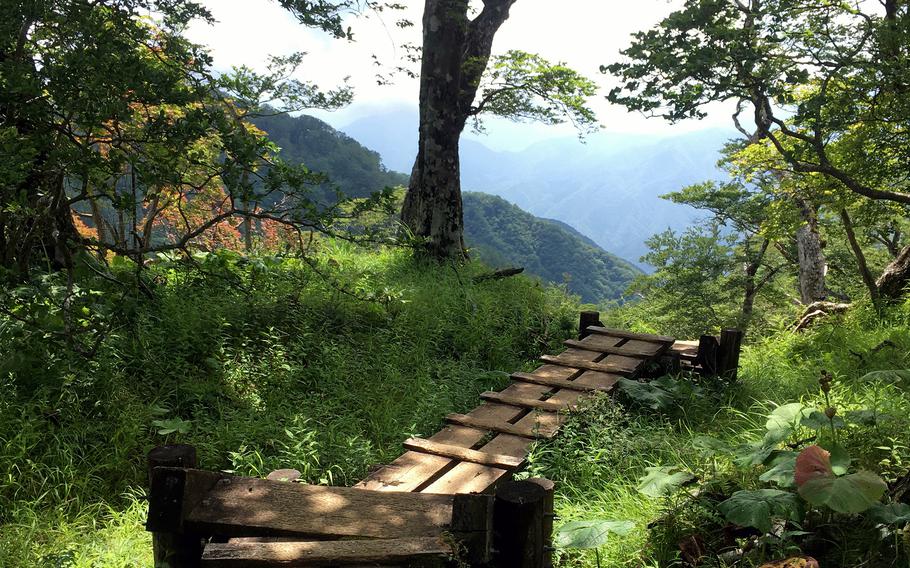 A wooden walkway seems to lead to distant peaks from the summit of  Mount Hinokiboramaru in Kanagawa prefecture, Japan.