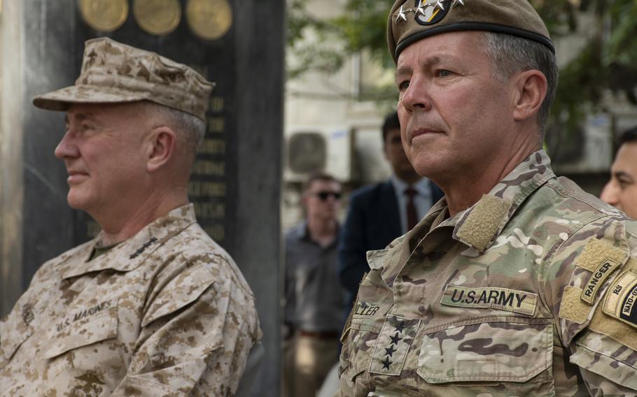 Army Gen. Scott Miller, right, sits next to Marine Corps Gen. Frank McKenzie at a ceremony in Kabul, Afghanistan, on Monday, July 12, 2021. Miller relinquished command of United States Forces-Afghanistan and NATOs Resolute Support mission to McKenzie. 