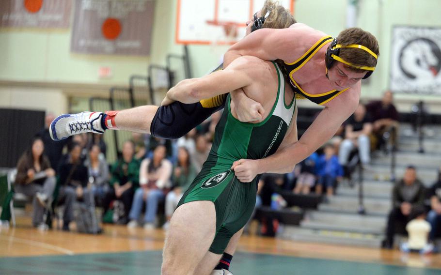 Kubasaki 172-pounder Kaiser Armour sends Kadena's Ryder Livingston airborne during Wednesday's Okinawa wrestling dual meet. Armour pinned Livingston in 29 seconds, but the Panthers won the meet 34-28, improving to 4-0 over the Dragons this season.