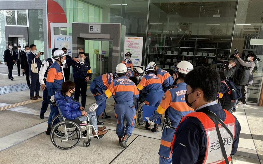 Members of the Naha Fire Corps assist people in wheelchairs during a missile evacuation drill in Naha, Okinawa, Jan. 21, 2023.