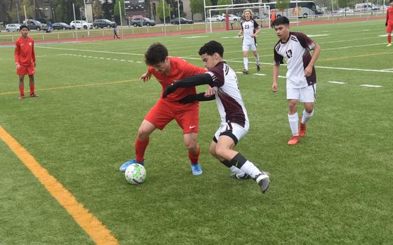 Vilseck's Gabe Daiz battles Kaiserslauterns's Jason Niemi for the ball during a soccer game in Kaiserslautern, Germany, on Saturday, April 30, 2022. The Raider won the game 4-3.