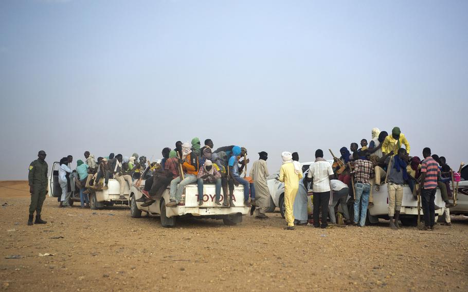 This June 14, 2018, file photo shows Nigeriens and third-country migrants head towards Libya from Agadez, Niger.