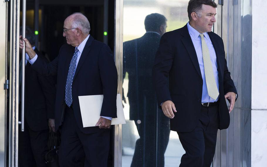 FBI agent Scott Carpenter, right, leaves the Lloyd George U.S. Courthouse after his sentencing on Wednesday, Aug. 17, 2022, in Las Vegas. Carpenter was sentenced to 90 days in custody for gambling away $13,000 in government money.