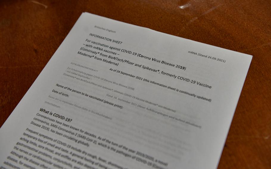 Red Cross workers have English briefing sheets available for international recipients of the COVID-19 vaccine at a vaccination event in Kaiserslautern, Germany, Nov. 30, 2021. 