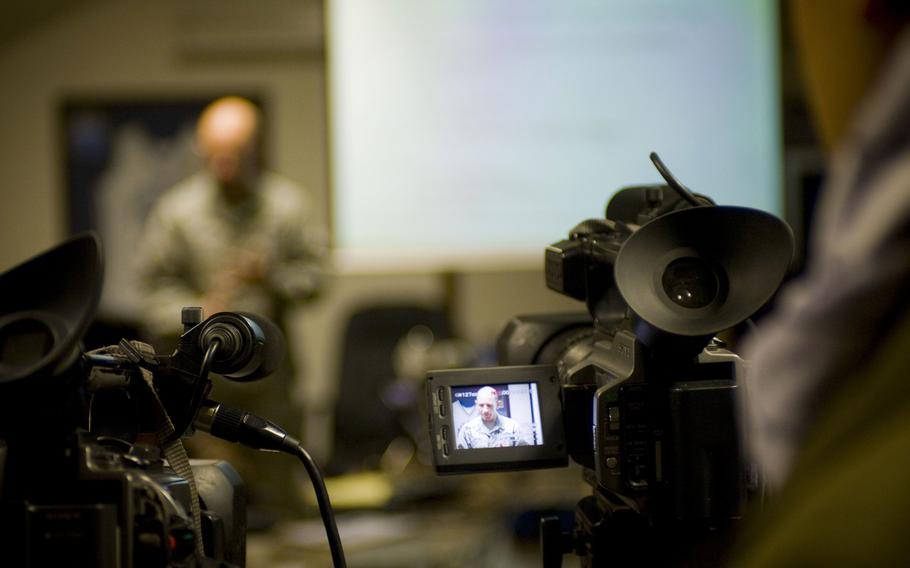 A cameraman captures a briefing at Bagram Airfield, Afghanistan, in 2009. Afghans who worked with American news companies should be given emergency visas to relocate to the United States, a group of media outlets and press freedom organizations have said. 