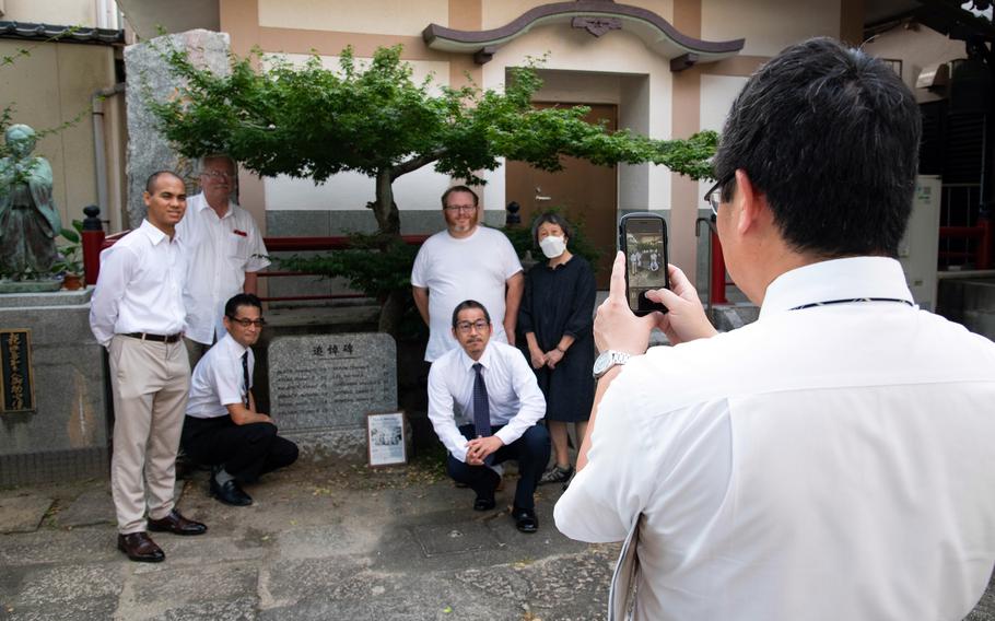 Visitors pose with a monument in Japan.