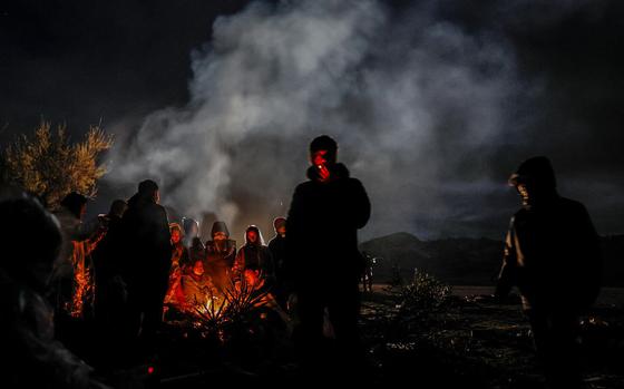 Asylum seekers from China camp near the border wall near Jacumba, Calif., on Nov. 24, 2023, often waiting days to be transported by the U.S. Border Patrol. 
